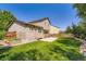 Spacious backyard featuring a green lawn, patio, and fenced perimeter at 5534 S Wenatchee St, Aurora, CO 80015