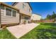 Backyard featuring a stone patio, a small lawn, and a fenced perimeter at 5534 S Wenatchee St, Aurora, CO 80015