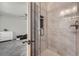 Modern bathroom featuring a glass-enclosed tiled shower, with a doorway into the bedroom at 5534 S Wenatchee St, Aurora, CO 80015