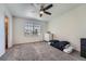 Bright bedroom with carpet, ceiling fan, a window with blinds and a white dresser at 5534 S Wenatchee St, Aurora, CO 80015