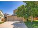 Two story home with a three car garage, well maintained lawn, and mature landscaping at 5534 S Wenatchee St, Aurora, CO 80015