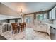 Eat-in kitchen featuring a dining table, stainless steel appliances, tile flooring, and generous natural light at 5534 S Wenatchee St, Aurora, CO 80015
