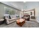 Relaxing living room featuring comfortable seating, carpet flooring, and view into the dining area at 5534 S Wenatchee St, Aurora, CO 80015