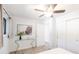 Bedroom with a glass table, ceiling fan, and ample natural light streaming in through a large window at 1476 W Dakota Ave, Denver, CO 80223