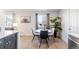 Eat-in dining area with a round table, modern chairs, a leafy plant, and natural light from the window at 1476 W Dakota Ave, Denver, CO 80223