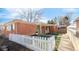 Charming brick home with a well-manicured front yard and a classic white picket fence under a sunny sky at 1476 W Dakota Ave, Denver, CO 80223