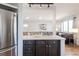 Modern kitchen with stainless steel appliances, quartz countertops, and an open concept design to the living room at 1476 W Dakota Ave, Denver, CO 80223