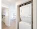 Convenient laundry area with stacked washer and dryer, offering efficient space-saving design at 1476 W Dakota Ave, Denver, CO 80223