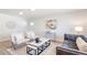 Modern living room with neutral tones, sleek furniture, and ample natural light creating a comfortable space at 1476 W Dakota Ave, Denver, CO 80223