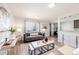 Cozy living room with contemporary furnishings, large windows, and an open layout leading to the dining area at 1476 W Dakota Ave, Denver, CO 80223