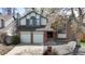 Two-story home featuring brick accents, a two-car garage, and mature trees in the yard at 6726 Taft Cir, Arvada, CO 80004