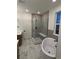 Contemporary bathroom showcasing a glass-enclosed shower with a built-in bench and a freestanding tub for a spa-like experience at 5621 W 141St Ln, Broomfield, CO 80020