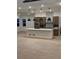 Contemporary kitchen with large island, pendant lights, and sleek cabinetry at 5621 W 141St Ln, Broomfield, CO 80020