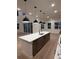 Stylish kitchen with white countertop island and seating, pendant lighting, and adjacent living space at 5621 W 141St Ln, Broomfield, CO 80020