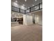 Open-concept living space with high ceilings, wood floors, and modern staircase at 5621 W 141St Ln, Broomfield, CO 80020