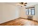 Bedroom featuring hardwood floors, black framed window, radiator heating and ceiling fan at 1182 N Clermont St # 101, Denver, CO 80220