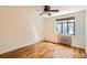 Bright bedroom features hardwood floors, black framed window, radiator heating and ceiling fan at 1182 N Clermont St # 101, Denver, CO 80220