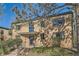 Brick apartment building with mature trees and landscaping in front at 1182 N Clermont St # 101, Denver, CO 80220
