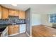 Bright kitchen features stylish backsplash, light wood cabinets, and appliances including a dishwasher at 1182 N Clermont St # 101, Denver, CO 80220