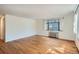 Empty living room with hardwood floors and large windows at 1182 N Clermont St # 101, Denver, CO 80220