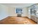 Empty living room with hardwood floors and large windows at 1182 N Clermont St # 101, Denver, CO 80220