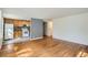Living room with hardwood floors leading to an open kitchen space at 1182 N Clermont St # 101, Denver, CO 80220