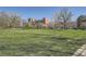 Expansive park with green space and city views beyond the trees at 1182 N Clermont St # 101, Denver, CO 80220