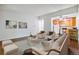 Cozy living room with wood floors, and furniture leading into an updated kitchen at 9385 E Center Ave # 1D, Denver, CO 80247