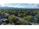 An elevated view highlights a neighborhood surrounded by lush greenery and trees at 12555 W 61St Ave, Arvada, CO 80004