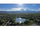 An expansive aerial view captures a neighborhood bordering a lake, offering scenic beauty and recreational opportunities at 12555 W 61St Ave, Arvada, CO 80004