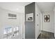 Bright hallway featuring a split-level staircase and decorative wall art at 12555 W 61St Ave, Arvada, CO 80004