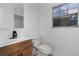 Bright half bath with updated vanity and fixtures, plus a window with natural light at 12635 E Pacific Cir # A, Aurora, CO 80014