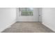 Inviting bedroom with neutral carpeting, a large window, and white trim at 12635 E Pacific Cir # A, Aurora, CO 80014