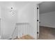 Bright hallway with white walls, wood-look flooring, and a modern light fixture creates an inviting and fresh transition space at 12635 E Pacific Cir # A, Aurora, CO 80014