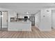 Open-concept area showcasing stainless steel appliances and updated lighting fixtures at 12635 E Pacific Cir # A, Aurora, CO 80014