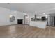 Open floor plan featuring a fireplace, ample lighting and a modern kitchen with stainless appliances at 12635 E Pacific Cir # A, Aurora, CO 80014