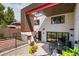 A modern backyard features a patio, outdoor dining area, and fireplace with plenty of room for entertaining at 111 S Hudson St, Denver, CO 80246