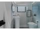 Modern bathroom featuring a floating sink, glass shower, and tiled walls at 111 S Hudson St, Denver, CO 80246