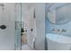 Stylish bathroom featuring penny tile, glass shower, and a modern pedestal sink at 111 S Hudson St, Denver, CO 80246