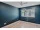 A cozy bedroom features hardwood floors, a ceiling fan, and large window with backyard views at 111 S Hudson St, Denver, CO 80246