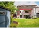 The home has a manicured lawn and a backyard with a patio, great for outdoor entertaining at 111 S Hudson St, Denver, CO 80246