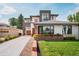 Modern home featuring a well-manicured lawn, beautiful landscaping, and an attached two car garage at 111 S Hudson St, Denver, CO 80246