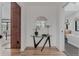 Stylish hallway featuring a decorative mirror above a table and leading to a luxurious bathroom with a modern soaking tub at 111 S Hudson St, Denver, CO 80246