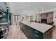 Kitchen with a long countertop with a view of the living room's brick fireplace at 111 S Hudson St, Denver, CO 80246