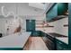 Bright kitchen with stainless steel appliances, emerald cabinetry, and an island with seating at 111 S Hudson St, Denver, CO 80246