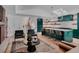 Open floorplan featuring hardwood floors, kitchen island with seating, and brick fireplace at 111 S Hudson St, Denver, CO 80246