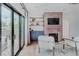 Cozy living room featuring a brick fireplace, built-in shelving, and large sliding doors leading to an outdoor patio at 111 S Hudson St, Denver, CO 80246