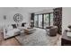 Open concept living room featuring comfortable seating, a large clock, and access to the patio at 111 S Hudson St, Denver, CO 80246
