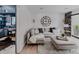Comfortable living room featuring a sectional sofa, ottoman, and a large clock on the wall at 111 S Hudson St, Denver, CO 80246