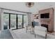 Bright main bedroom showcasing an ensuite brick fireplace and seamless access to an outdoor patio and living space at 111 S Hudson St, Denver, CO 80246